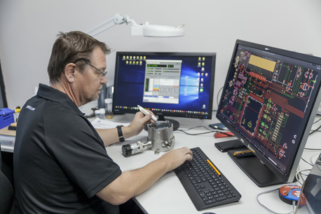 man at desk analysing gas detec tor schematic